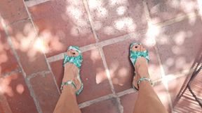 Milah driving and pedal pumping on green flat sandals