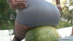 Charming brunette babe smashes watermelon with juicy ass