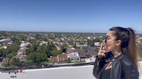 Angie crushing a cigarette in the rooftop with leather combat boots