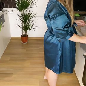 Sexy mother-in-law in a silk robe pees in the kitchen for her son-in-law