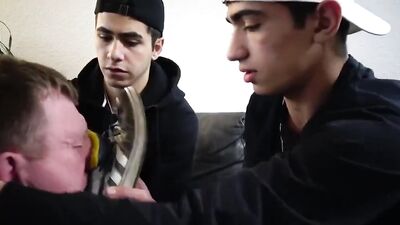 Foot slave is being dominated and humiliated by two kinky twinks