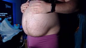 Belly inflation in purple boyshorts