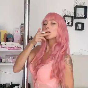 A sweet girl dances sexy while smoking