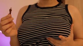 Giant girl plays with a tiny man because she can, because she has power over him, since the man is very small and the girl is huge, so the girl takes the opportunity to squeeze the girl's big breasts, plays with them, then takes them in her mouth and
