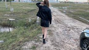 A girl in high-heeled boots walks through very deep mud, mud is poured into the boots and they get wet