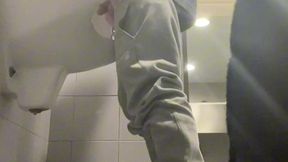 2 boys in sneakers having fun at public toilets  urinal