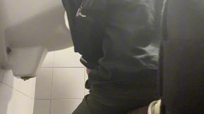 2 boys in sneakers having fun at public toilets  urinal