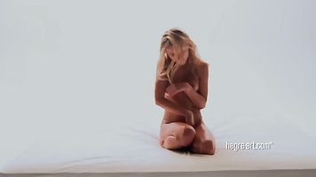 Slim blonde, Candice B is posing naked in front of the camera and enjoying it