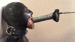 Rubber pig throat fucked by machine