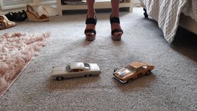 Giantess Charn vs 1965 Pontiac 2+2 and a scrap Ford pinto toy car crush in chunky cork heels ground view,