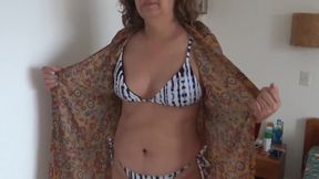 Hairy Latina steps on the beach while her son watches her