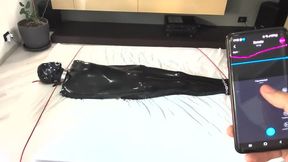 BDSM gay trapped in a latex vacsack with a vibrating anal plug
