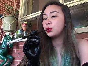 Asian retro smoking with gloves and cigarette holder