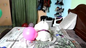 game in bed with colorful balloons