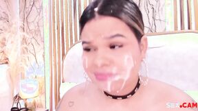 chubby hottie with fake cum on her face sucks a big dildo