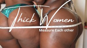 2 Thick women measuring each other