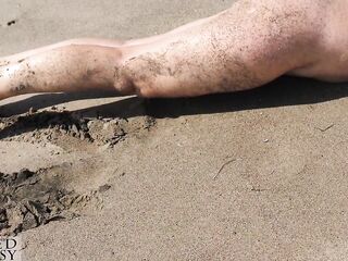 Sexy woman with a indecent twat at a secluded beach with see through white top