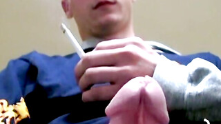 Twink savors the pleasure of smoking and stroking cock