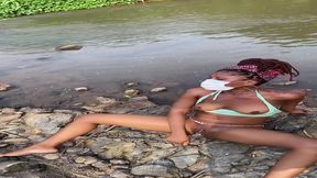 Ebony MILF masturbates by a stream and exhibits off her big booty while using
