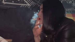 SANDY LYING DOWN IN A LEATHER JACKET SMOKING
