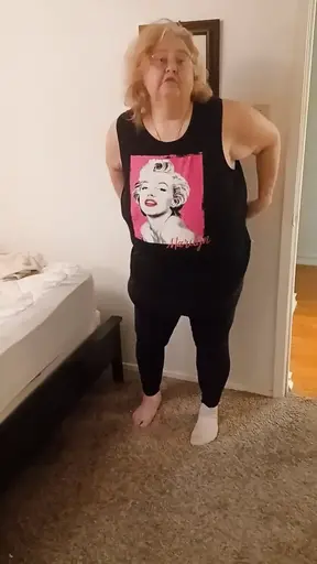Mature mom strips off star shirt and shows off her big natural boobs