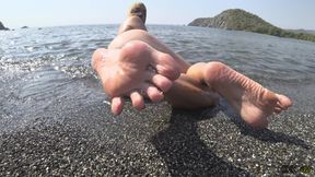 Wet barefoot play on a beach