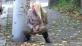 Lusty blond MILF in autumn coat pisses in the mid of the street