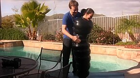 Julia in an inflatable latex cocoon in pool