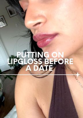 putting on my lip gloss before going out for the night