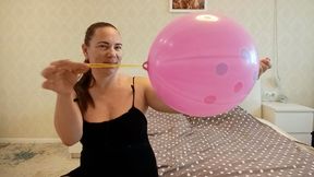 Inflating a pink punch ball until it bursts