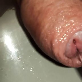 extreme close up of uncutted cock. foreskin play while piss