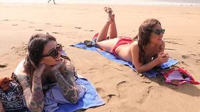 Three topless bikini girls are having fin on the beach