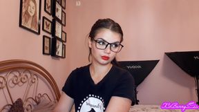Sensual brunette smoking and wearing geek glasses