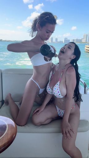 Couple and friends enjoy a luxury yacht party in their summer outfits