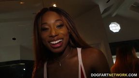 Hot, ebony babe, Kinsley Karter is sucking a white cock through a gloryhole and enjoying it