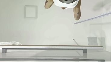 Miniskirt lover raver girl reveals her piercing on her pussy in the bathroom by lifting her short skirt