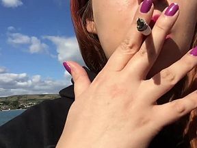 Sexy Redhead Teen in Black with Long Hair Smoking on the Beach in England