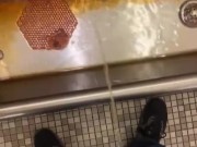 Taking a piss at an old urinal trough