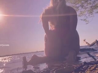 Bikini ass teasing in the water at a public beach!