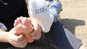 Chinese woman's feet are tickled by the river