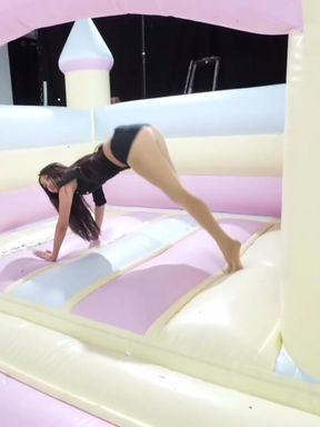 Woman in bikini on inflatable slide