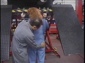 Brunette joins mechanic and fondles redhead's ass