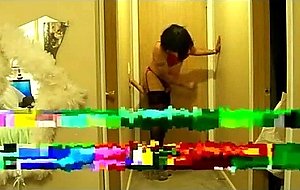 Amateur crossdresser with vibrator on a bed