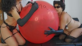 Marianna and Tiffany playing with a large 36 -inch balloon to deflate