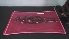 A black latex vacuum cocoon with a girl shaking from orgasms inside a vacuum bed