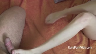 A petite, cheerful  eighteen chick doing a footjob and a blowjob