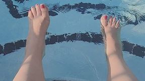 Splashing feet in pool with pink nail polish -JunieRose