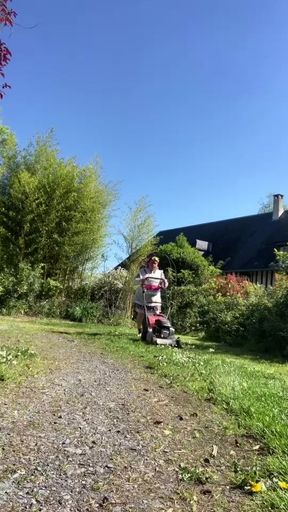 In gardening attire with a layer to mow the lawn.