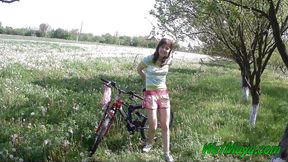 Peeing on her bicycle