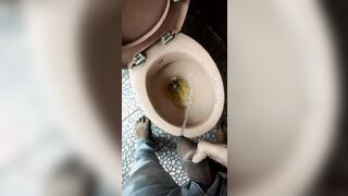 Indian boy pissing in toilet